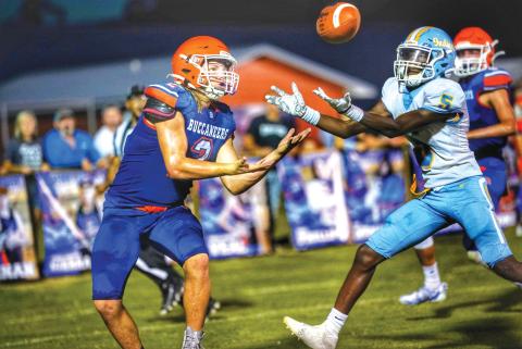 Branford slot receiver Caden Coker (left) battles a Chiefland defender for a pass Friday night. (BRIAN LEWIS/Special to the Reporter)