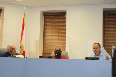 Lake City Council member Chris Greene holds a copy of his notice of proposed tax bill up during the council’s meeting Tuesday. (TONY BRITT/Lake City Reporter)