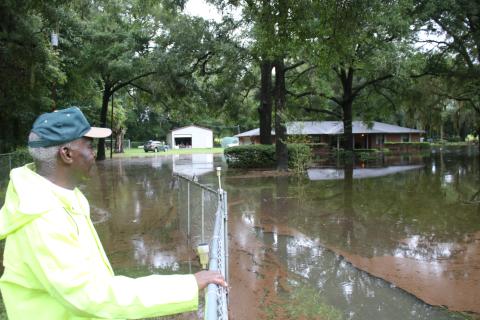 Walter Enman looks over the flooding surrounding his property north of Fort White. (TONY BRITT/Lake City Reporter)