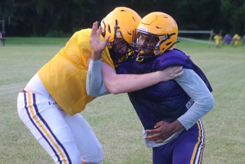 Columbia defensive end Adeon Farmer fights to get past offensive tackle Travis Matthews during practice on Aug. 13. (JORDAN KROEGER/Lake City Reporter)