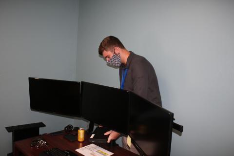 New Lake City IT Director Matt Benedetti works on a desktop setup Wednesday. (TONY BRITT/Lake City Reporter)