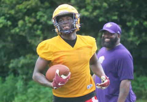 Columbia receiver Marcus Peterson smiles after scoring a touchdown during practice on Tuesday. (JORDAN KROEGER/Lake City Reporter)