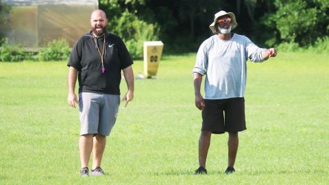 Columbia co-defensive coordinators John Woodley (left) and Shea Showers (right) call out a play to the defense during practice on Aug. 11. (JORDAN KROEGER/Lake City Reporter)