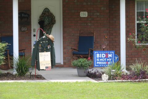 Retired Army corporal Michael Post’s uniform hangs in his front yard on the west side of Lake City alongside a ‘Biden is not my president’ sign. (JAMIE WACHTER/Lake City Reporter)