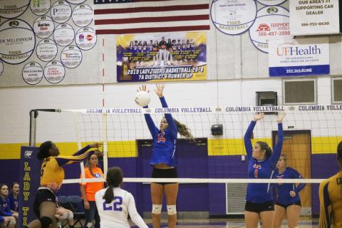 Branford’s Evie Pitts rises to block a shot from Columbia’s Zimora Owens during a match last season. (JORDAN KROEGER/Lake City Reporter)