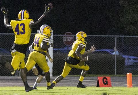 Columbia defensive end Adeon Farmer returns a fumble for a touchdown against American Heritage-Delray on Friday. (JEN CHASTEEN/Special to the Reporter)