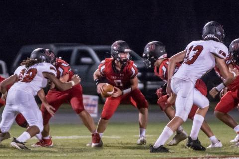 Fort White quarterback Clayton Philpot turns to hand the ball off against Middleburg during the teams’ Preseason Classic on Aug. 20. (CHRISTINA FEAGIN/Special to the Reporter)