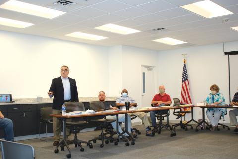 Kurt Spitzer (left) gives a presentation about building redistricting maps Wednesday afternoon. (TONY BRITT/Lake City Reporter)