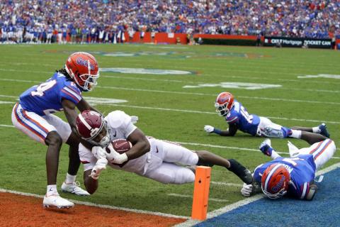 Alabama running back Jase McClellan runs past Florida cornerback Avery Helm, left, and linebacker Jeremiah Moon, right, to score a touchdown on Sept. 18 in Gainesville. (JOHN RAOUX/Associated Press)