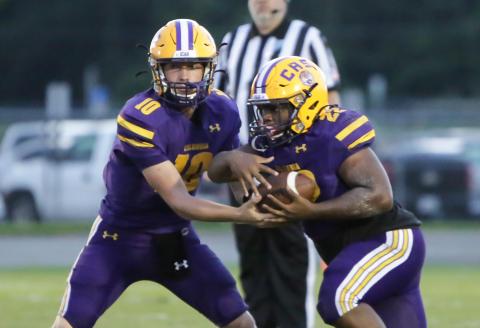 Columbia quarterback Kade Jackson hands the ball off to running back Tony Fulton against Bolles on Sept. 3. (BRENT KUYKENDALL/Lake City Reporter)