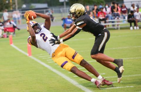 Columbia High wide receiver Marcus Peterson hauls in a pass along the sideline Friday in front of an Oakleaf defensive back. (BRENT KUYKENDALL/Lake City Reporter)
