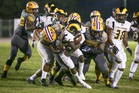 Columbia linebacker Tyrell Peterson (23) and defensive tackle Jihycein Weston (57) tackle Englewood running back Tayshaun Solomon on Friday night. (BRENT KUYKENDALL/Lake City Reporter)