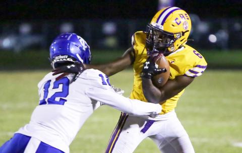 Columbia receiver Tray Tolliver tries to escape a tackle from Trinity Christian defensive back Tyler Jackson on Friday night. (BRENT KUYKENDALL/Lake City Reporter)