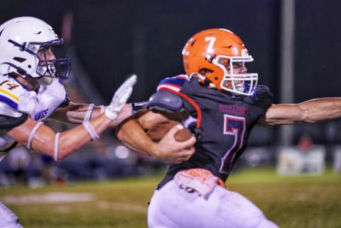 Branford running back Bodhi White breaks away from a Bell defender for a touchdown Friday night. (BRIAN LEWIS/Special to the Reporter)