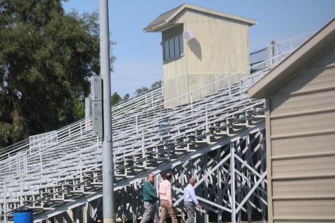 Lake City Growth Management Director David Young (left) tours the facility at Memorial Stadium Monday afternoon. (TONY BRITT/Lake City Reporter)