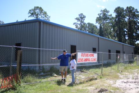 Keith Williams (left), Lake City-Columbia County Humane Society board of directors president talks to Robin Tobak Ward, LCHS executive director, Friday morning while aiding with the construction of the James Montgomery Animal Wellness Center. Officials hope to open the facility in December. (TONY BRITT/Lake City Reporter)