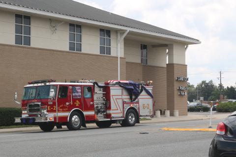 A Lake City fire truck carrying Randy Burnham, the city’s fallen fire chief, passes by the Lake City Fire Department Station 1 on Friday afternoon on its way to the Corinth Methodist Church cemetery. (JAMIE WACHTER/Lake City Reporter)