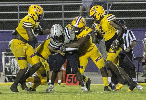 Columbia linebacker Tyrell Peterson wraps up American Heritage-Delray receiver Brandyn Butler with help from teammates on Aug. 27. (JEN CHASTEEN/Special to the Reporter)