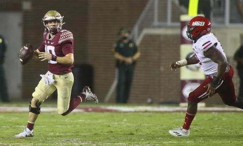 Florida State quarterback McKenzie Milton (10) scrambles out of the pocket as he is chased by Jacksonville State defensive end Umstead Sanders (12) on Sept. 11 in Tallahassee. Jacksonville State won 20-17. (PHIL SEARS/Associated Press)