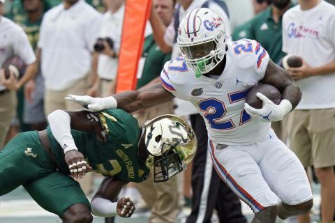 Florida running back Dameon Pierce gets past South Florida safety Vincent Davis on a run on Sept. 11 in Tampa. (CHRIS O'MEARA/Associated Press)