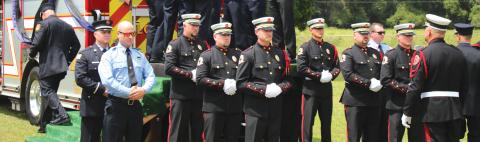 The Suwannee County Fire Rescue Honor Guard stands at attention at the funeral of former Chief Randy Burnham. (TONY BRITT/Lake City Reporter)