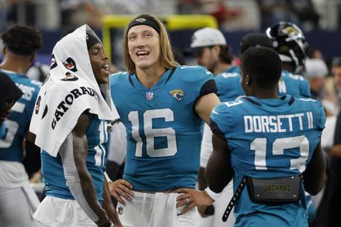 Jacksonville Jaguars' Laviska Shenault Jr., left, Trevor Lawrence (16) and Phillip Dorsett II (13) talk on the sideline during a preseason game against the Dallas Cowboys on Aug. 29, in Arlington, Texas. (MICHAEL AINSWORTH/Associated Press)