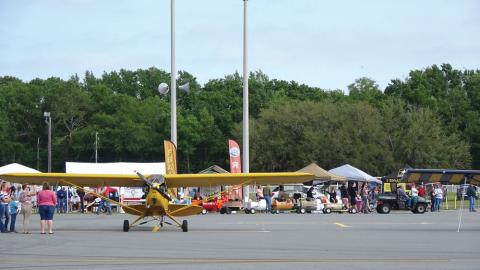 Spectators gather around a yellow airplane at a previous Wings Over Suwannee event at the Suwannee County Airport. (COURTESY)