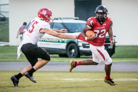 Fort White running back Kamarion Griffin escapes a tackle against Santa Fe on Friday night. (CHRISTINA FEAGIN/Special to the Reporter)