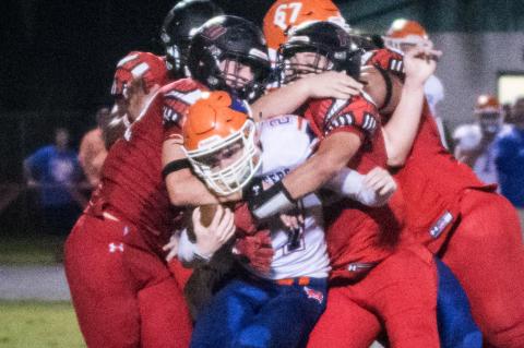 Branford receiver Brice Criggall gets tackled by a swarm of Fort White defenders on Friday night. (CHRISTINA FEAGIN/Special to the Reporter)