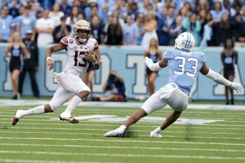 Florida State quarterback Jordan Travis (13) runs the ball against North Carolina linebacker Cedric Gray (33) on Oct. 9 in Chapel Hill, N.C. (GERRY BROOME/Associated Press)