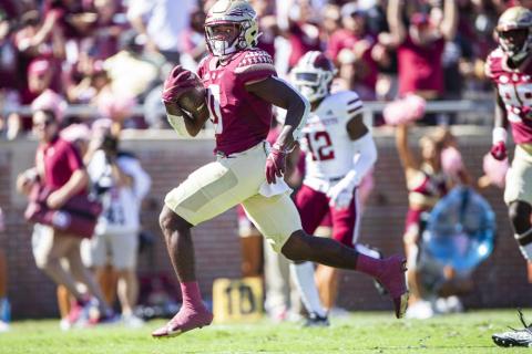 Florida State running back Jashaun Corbin (0) breaks through the line for a touchdown run against Massachusetts on Oct. 23 in Tallahassee. (MARK WALLHEISER/Associated Press) 