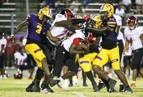 Columbia defensive back Jerome Fulton (3), defensive tackle Jihycein Weston (57) and defensive end Rashod Bradley (43) converge for a tackle vs. Westside on Oct. 1. (BRENT KUYKENDALL/Lake City Reporter) 