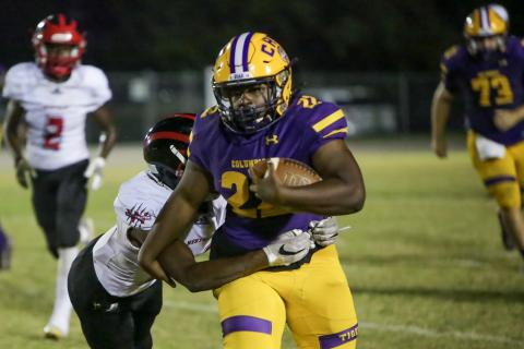 Columbia running back Tony Fulton tries to run through a tackle against Westside on Friday. (BRENT KUYKENDALL/Lake City Reporter)
