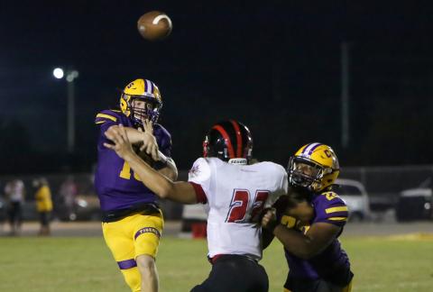 Columbia quarterback Kade Jackson throws a pass over a Westside defender last Friday. (BRENT KUYKENDALL/Lake City Reporter)