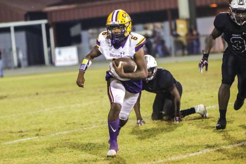 Columbia’s Tray Tolliver looks for room to run Friday against Madison County at Boot Hill Stadium. (BRENT KUYKENDALL/Lake City Reporter)