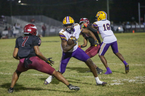 Columbia receiver Marcus Peterson looks to make move past Raines defensive back Kyree Hammond on Thursday. (BRENT KUYKENDALL/Lake City Reporter)
