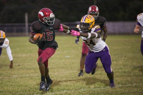 Raines’ Travis Laster stiff-arms Columbia linebacker Desavion Lee on Thursday. (BRENT KUYKENDALL/Lake City Reporter)