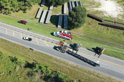 A full load of overturned building trusses shut down a portion of Bascom Norris Drive on Friday afternoon after the load shifted on the trailer coming out of a turn. (RAY CARPENTER/Special to the Reporter)