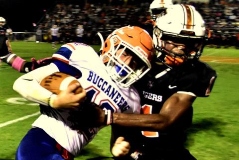 Branford receiver Adrik Miller is tackled by safety Tyler Perry on Oct. 8. (ROB WOLFE/Special to the Reporter)