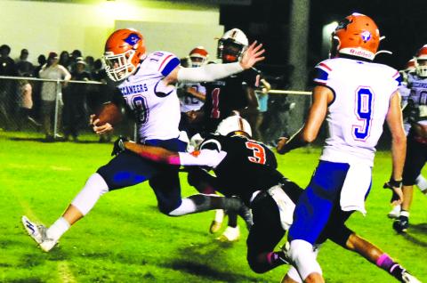 Branford quarterback Kyson Johnson gets hit by a Trenton defender just as he crosses the goal line for a touchdown on Friday. (ROB WOLFE/Special to the City Reporter)