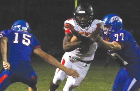 Fort White running back Darren Clark runs past Keystone Heights defensive lineman Trey Jeffries on Oct. 1. (MORGAN MCMULLEN/Lake City Reporter)