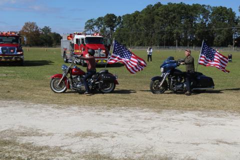 A pair of riders take off with American flags waving during the American Legion Riders’ 2019 Toys for Tots run. (FILE)