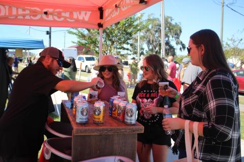 Derek Nelson (from left), of Woodchuck Hard Cider, pours a sample for Stacey Hentzelman, Britney Thrasher and Ava White. (TONY BRITT/Lake City Reporter)