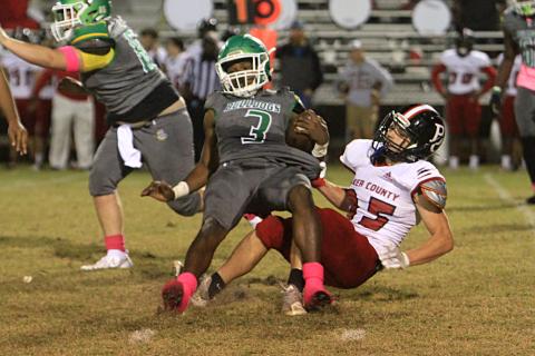 Suwannee running back Malachi Graham is tackled from behind by a Baker County defender on Friday. (PAUL BUCHANAN/Special to the Reporter)