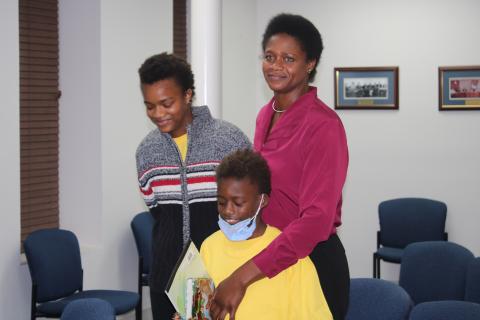 Befaithful Coker (right) stands with her two children, Victoria and Michael, in the council chambers. (TONY BRITT/Lake City Reporter)