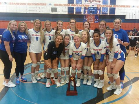 Branford’s volleyball team poses with the District 5-1A championship trophy after defeating Lafayette in five sets Thursday night. (CONCEPCION LEDEZMA/Special to the Reporter)