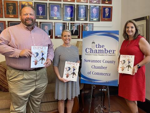 Hillary Cannon, center, executive director of the Suwannee County Chamber of Commerce stands with Lake City Reporter Publisher Todd Wilson, left, and Monja Slater, Lake City Reporter business development manager, during the unveiling of the Chamber’s 2021-2022 ‘Impact’ magazine this week. The Reporter partnered with the Suwannee Chamber to produce the annual magazine. (COURTESY)