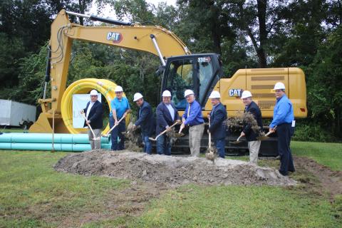 State and local officials Tom Kallemeyn (from left), Todd Sampson, Toby Witt, Rocky Ford, Stephen Witt, Tim Murphy, Dan Hartley and Hugh Thomas toss dirt during a ground breaking ceremony Wednesday for the State Road 47/I-75 Wastewater Improvements Project. (TONY BRITT/Lake City Reporter)