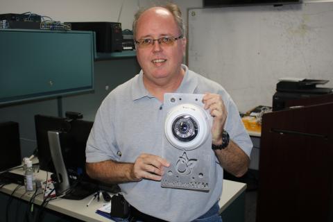 Shayne Morgan, Columbia County Emergency Management director, holds a WeatherSTEM monitor that was struck by lightning earlier this year. (TONY BRITT/Lake City Reporter)