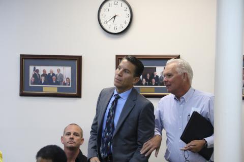 Stephen A. Douglas, left, is congratulaed by Mike McKee, of Florida Gateway College, after Douglas was appointed to the Lake City Council on Wednesday. (MORGAN MCMULLEN/Lake City Reporter)